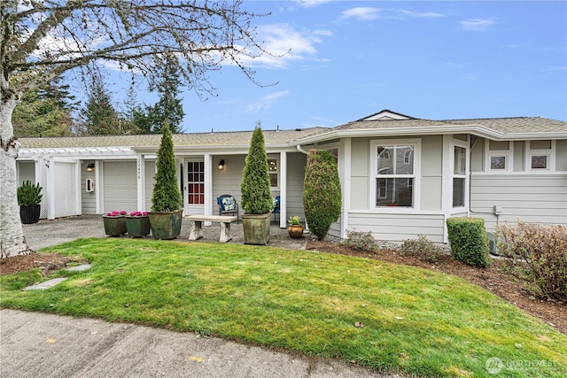 ranch-style house featuring driveway, a front yard, and a garage