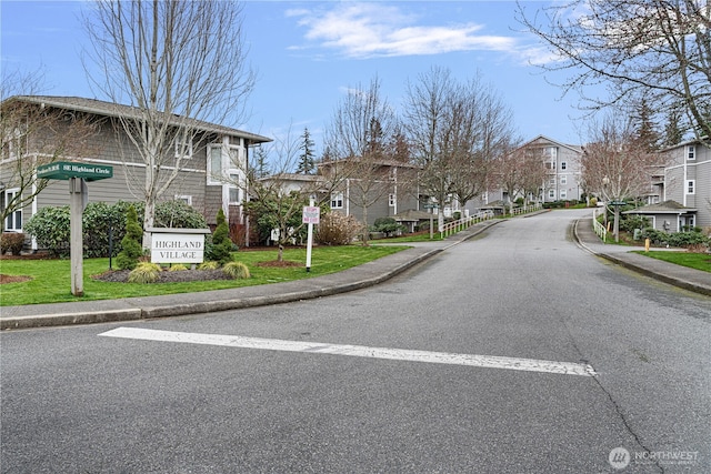 view of road with a residential view, curbs, and sidewalks