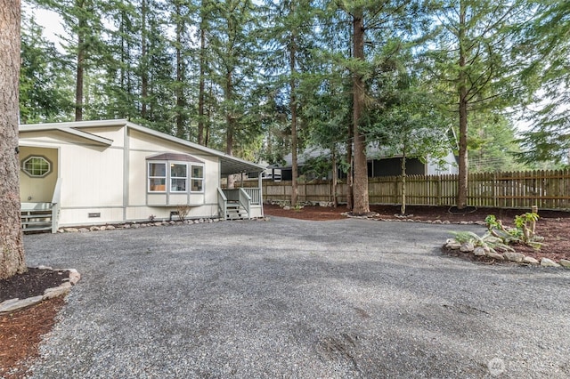 exterior space with aphalt driveway and fence