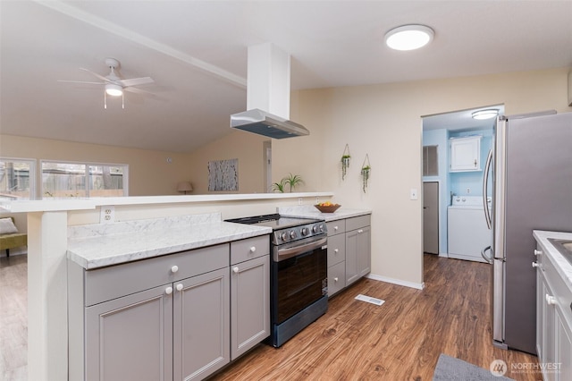 kitchen with ventilation hood, washer / clothes dryer, gray cabinets, ceiling fan, and appliances with stainless steel finishes