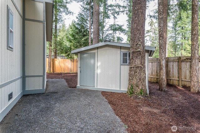 view of outdoor structure with an outbuilding and a fenced backyard