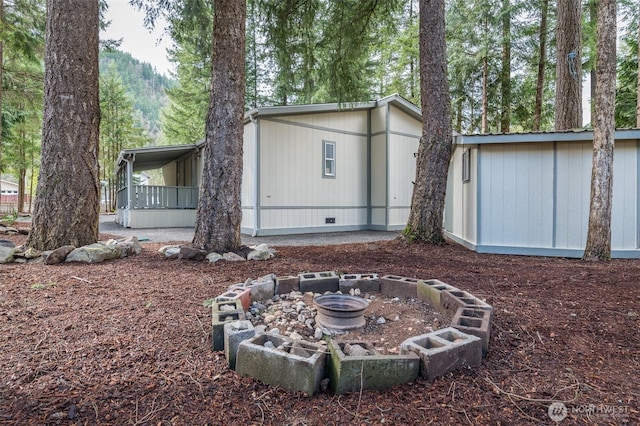 exterior space with a fire pit and crawl space