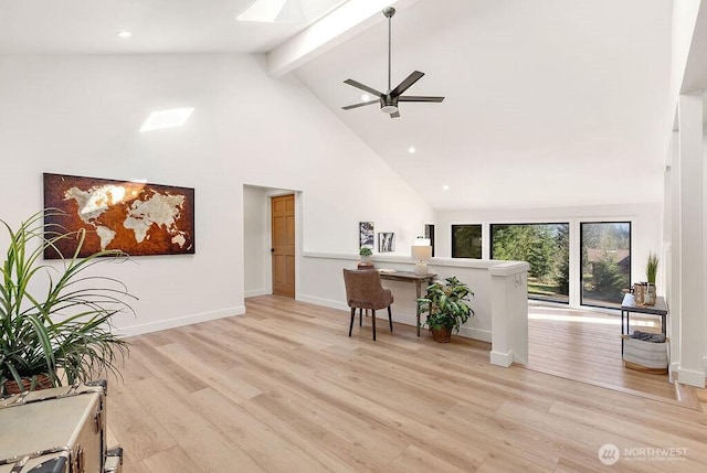 living area featuring beamed ceiling, high vaulted ceiling, light wood-type flooring, and baseboards