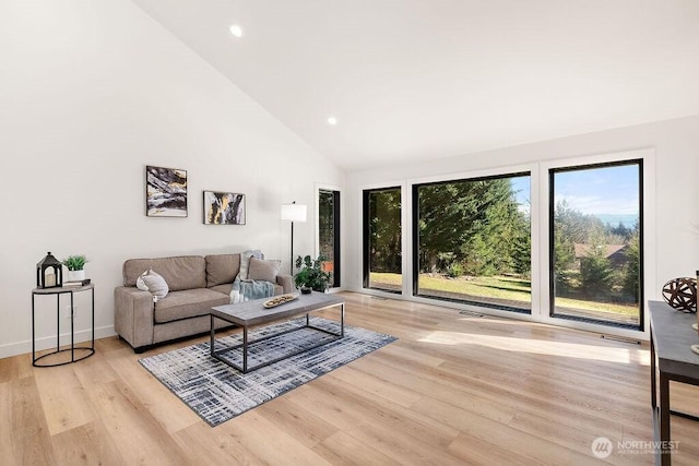 living room with visible vents, high vaulted ceiling, recessed lighting, light wood-style floors, and baseboards