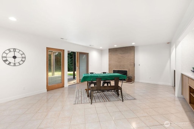 playroom with recessed lighting, baseboards, and a brick fireplace