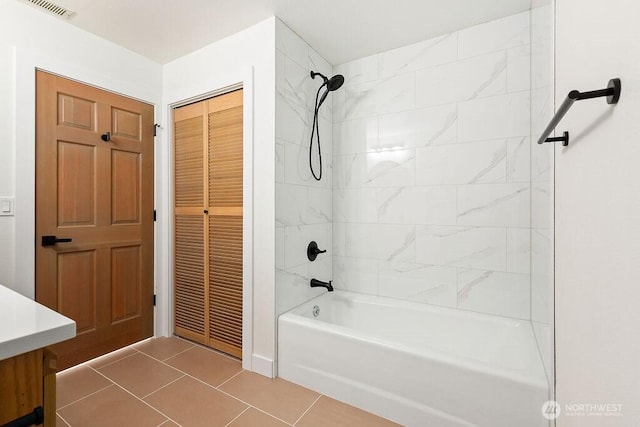 bathroom with tile patterned floors, visible vents, and washtub / shower combination