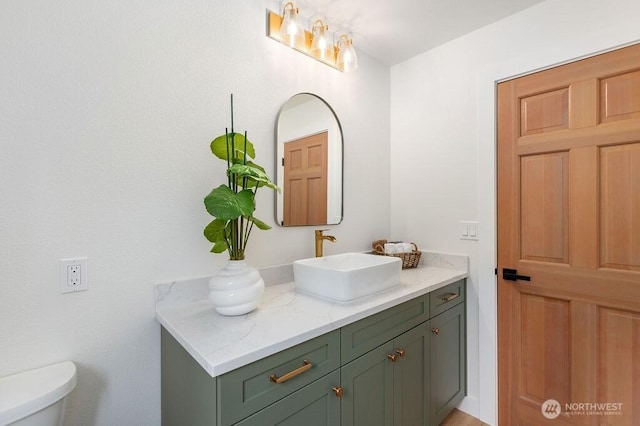 half bath featuring toilet and vanity