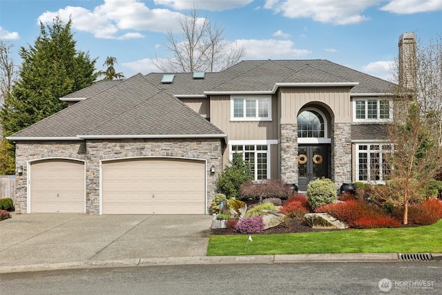 view of front of home featuring an attached garage, driveway, and a shingled roof