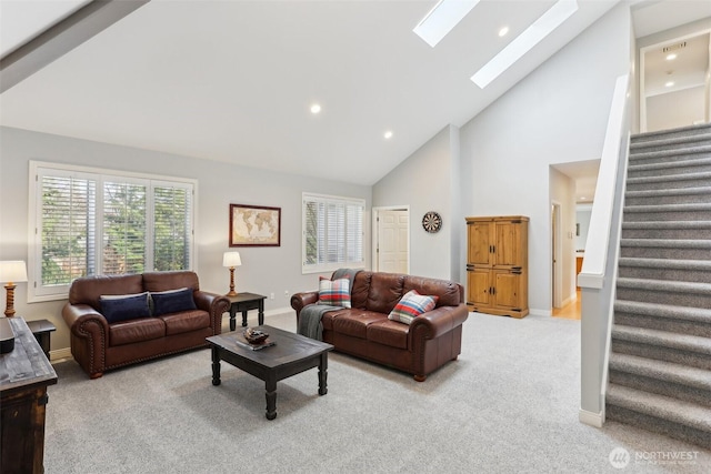 living room with recessed lighting, a skylight, baseboards, light colored carpet, and stairs