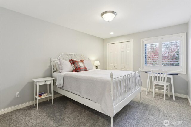 bedroom with a closet, carpet flooring, and baseboards