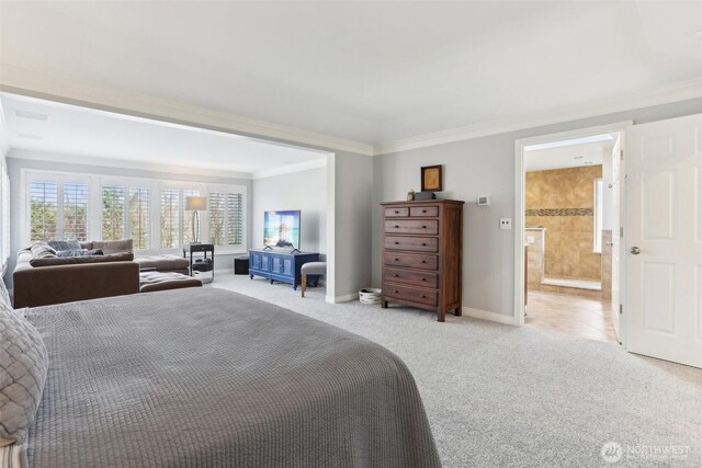 bedroom with light colored carpet, baseboards, ensuite bathroom, and ornamental molding