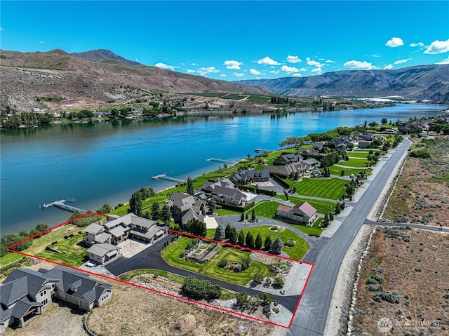 aerial view featuring a water and mountain view