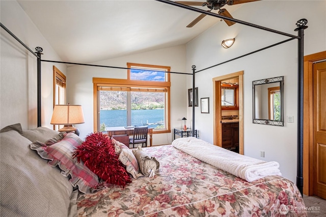 bedroom featuring ceiling fan, carpet, ensuite bath, and vaulted ceiling