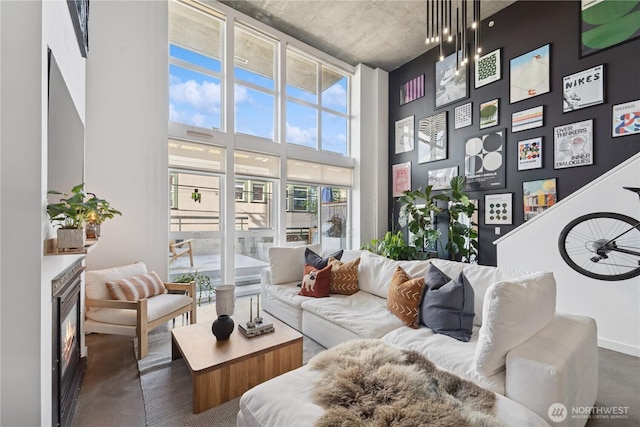 living room featuring a high ceiling and a fireplace