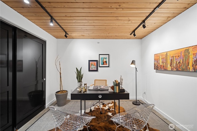 home office featuring wooden ceiling, rail lighting, and baseboards