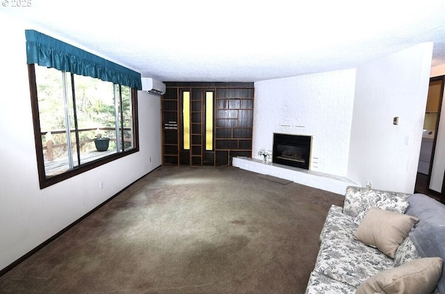 unfurnished living room with baseboards, a large fireplace, carpet, and a wall unit AC