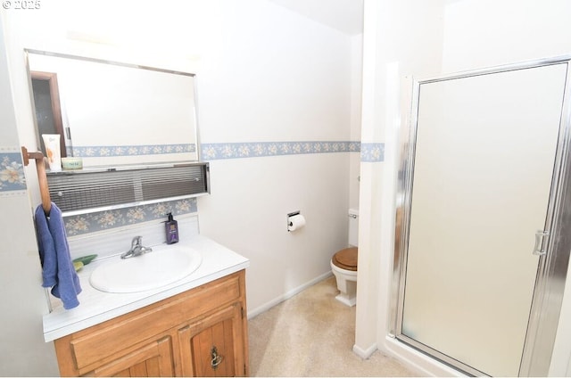 bathroom featuring toilet, a stall shower, and vanity