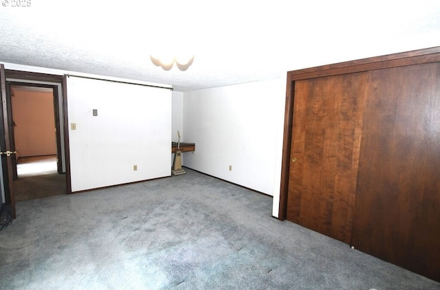 unfurnished bedroom with carpet floors and a textured ceiling