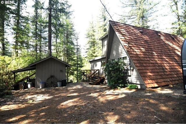 view of home's exterior with a storage unit and an outdoor structure