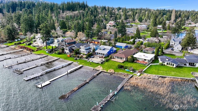 drone / aerial view featuring a residential view and a water view