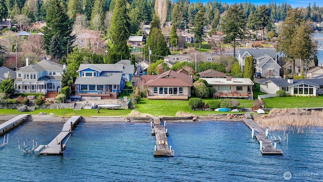 drone / aerial view featuring a residential view and a water view