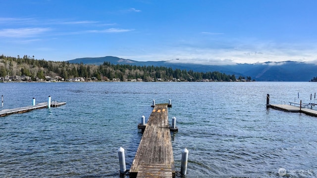 view of dock with a water and mountain view