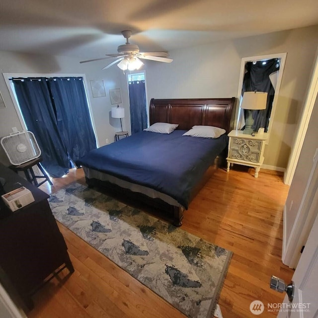 bedroom with a ceiling fan and light wood-style floors