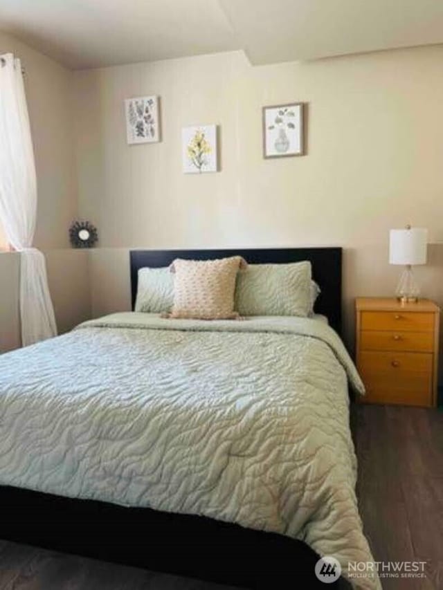 bedroom featuring wood finished floors