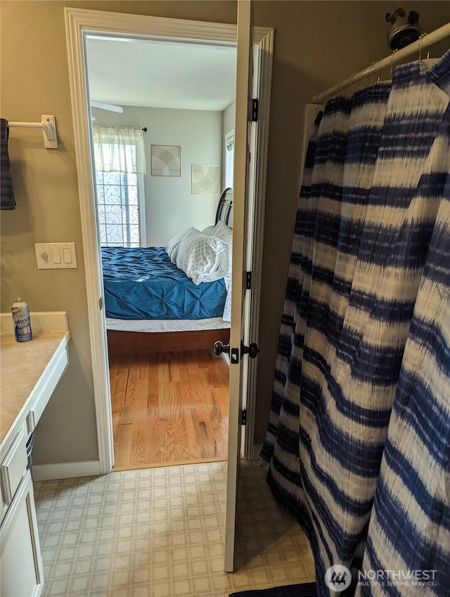 bedroom with light floors and baseboards