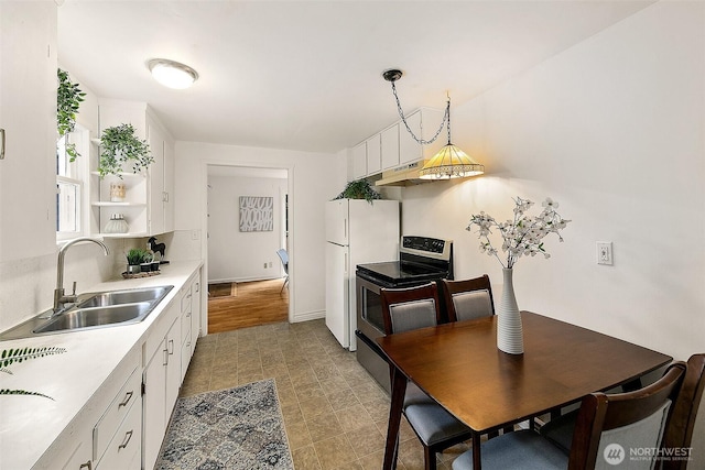 kitchen featuring a sink, light countertops, electric range, white cabinetry, and open shelves