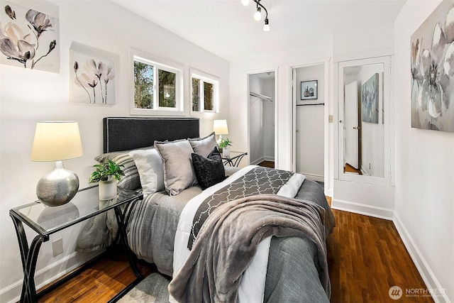 bedroom with a closet, baseboards, and wood finished floors