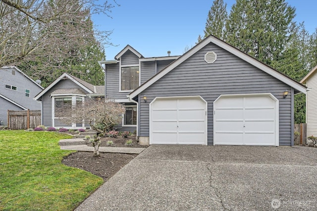 view of front facade with a garage, concrete driveway, a front yard, and fence