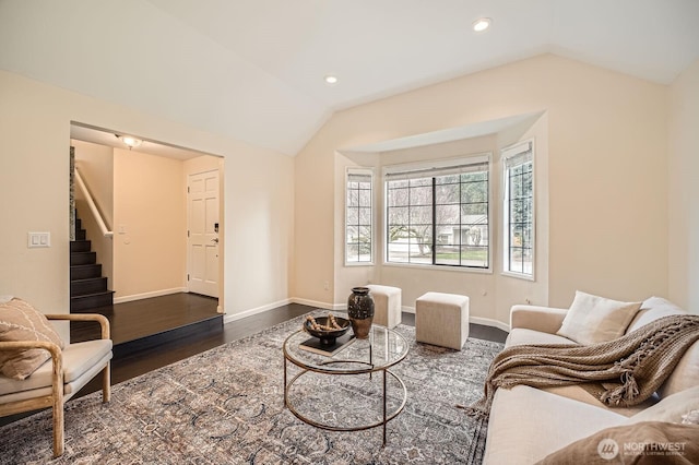 living area with dark wood-style floors, stairway, baseboards, and vaulted ceiling