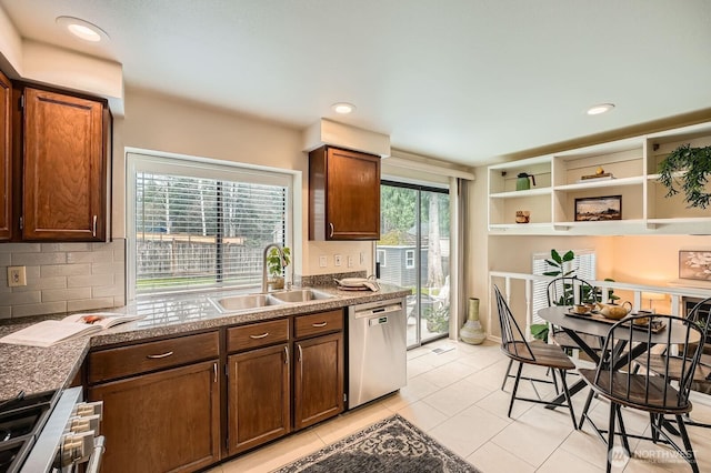 kitchen with a sink, tasteful backsplash, stainless steel dishwasher, and a healthy amount of sunlight