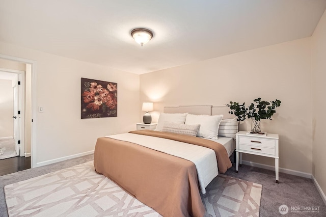 bedroom featuring baseboards and light carpet