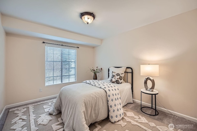 bedroom featuring light carpet and baseboards