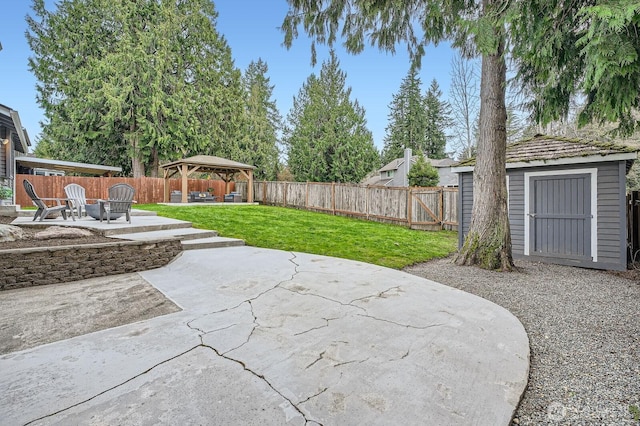 view of patio featuring a gazebo, a storage shed, a fenced backyard, and an outdoor structure