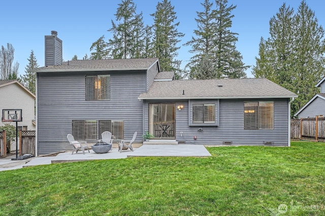 rear view of property with fence, an outdoor fire pit, a lawn, a chimney, and a patio area