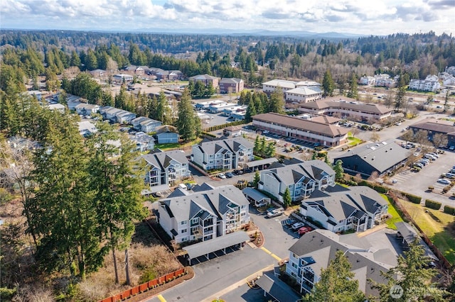 bird's eye view featuring a forest view and a residential view