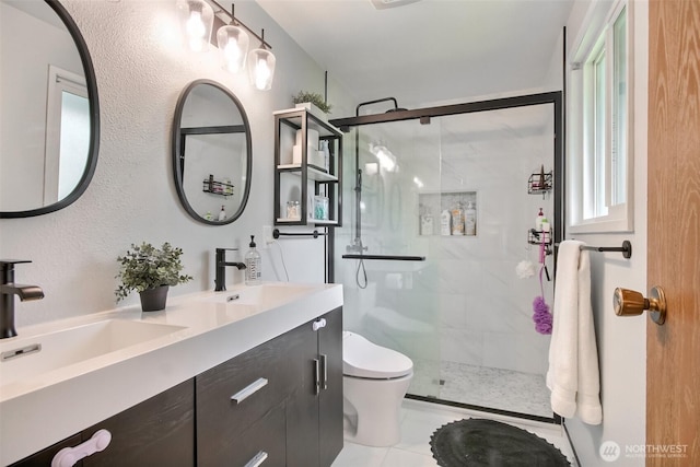 full bath featuring a shower stall, toilet, double vanity, and a sink