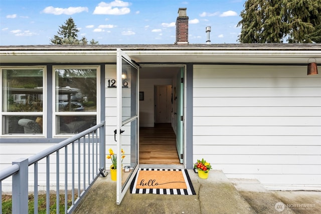 doorway to property featuring a chimney