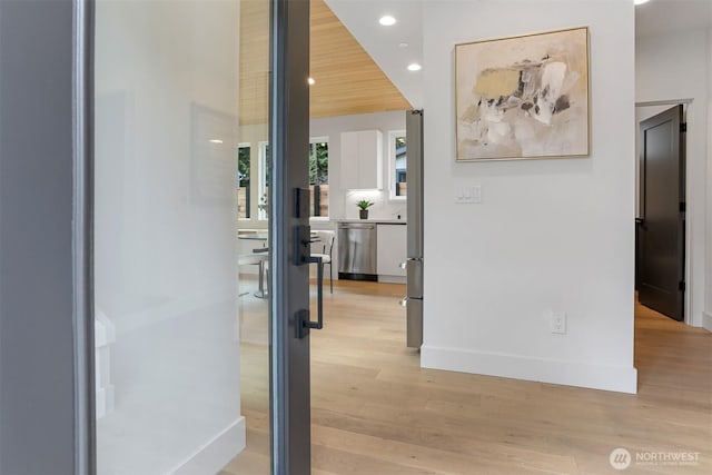 hall with recessed lighting, baseboards, and light wood-style flooring