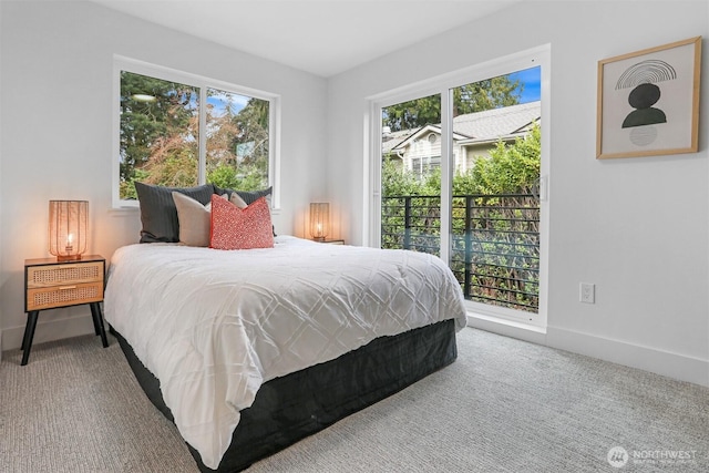 carpeted bedroom with access to outside and baseboards