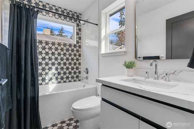 bathroom featuring vanity, toilet, and shower / tub combo