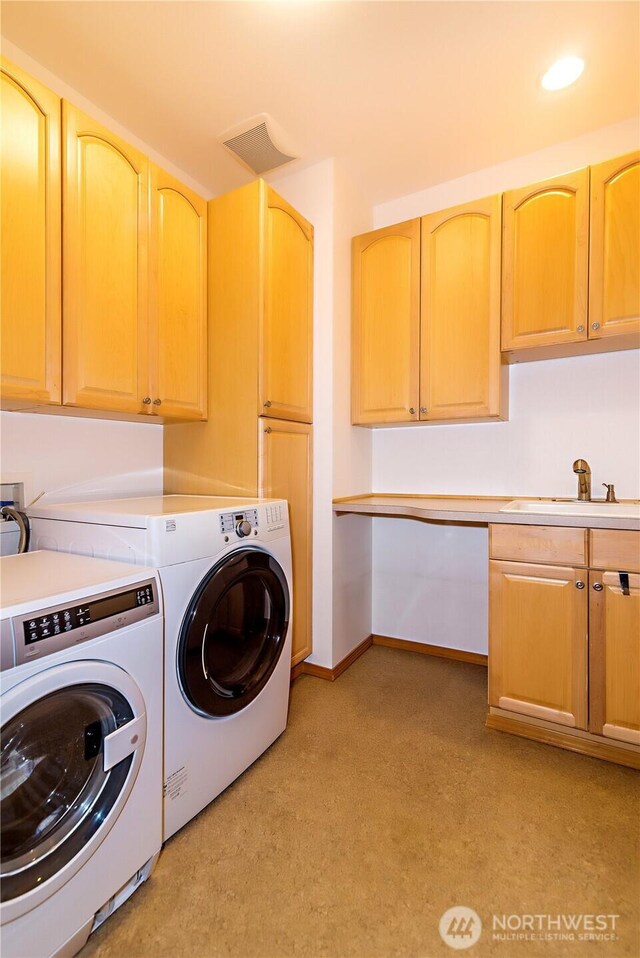 laundry room with visible vents, washing machine and dryer, recessed lighting, cabinet space, and a sink