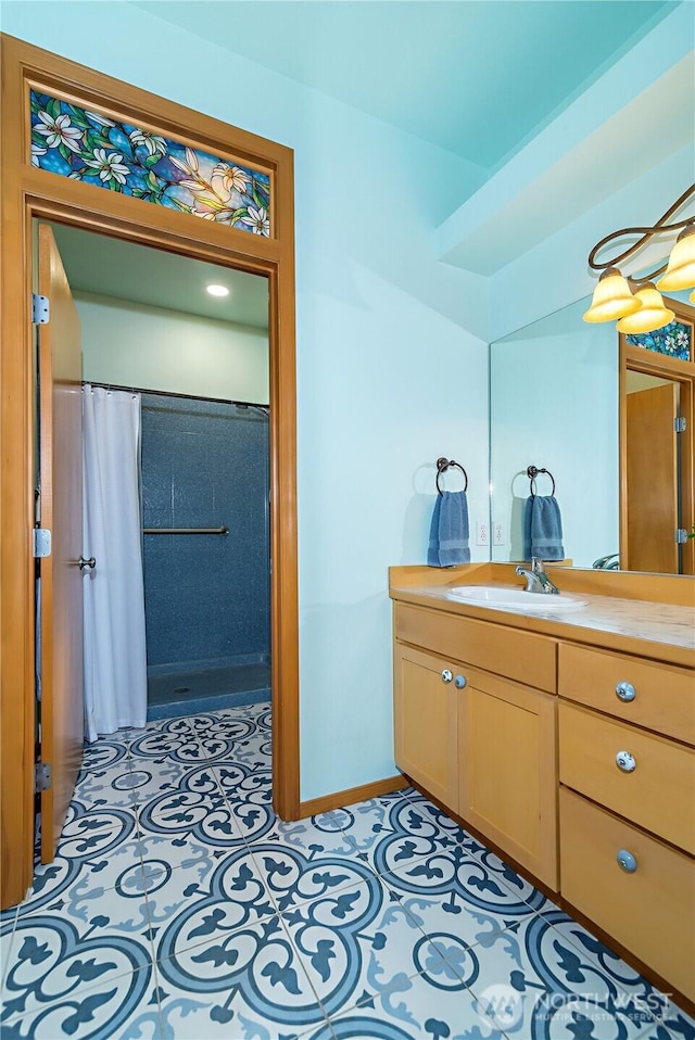 full bath with tile patterned floors, baseboards, a shower with curtain, and vanity