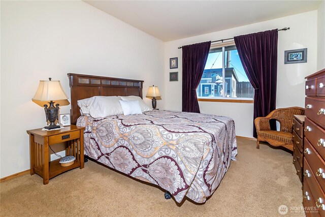 bedroom with baseboards, carpet flooring, and vaulted ceiling