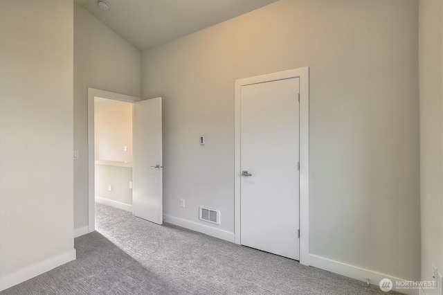 unfurnished bedroom featuring baseboards, visible vents, and carpet floors