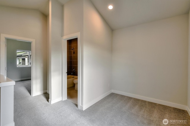 interior space featuring carpet flooring, recessed lighting, baseboards, and vaulted ceiling