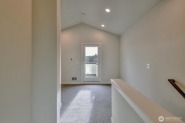 hallway with visible vents, recessed lighting, carpet, baseboards, and vaulted ceiling